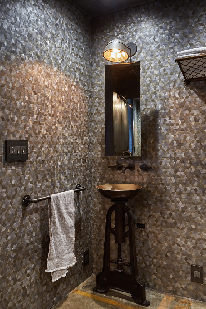 Photo of a mid-sized industrial powder room in Los Angeles with a vessel sink.