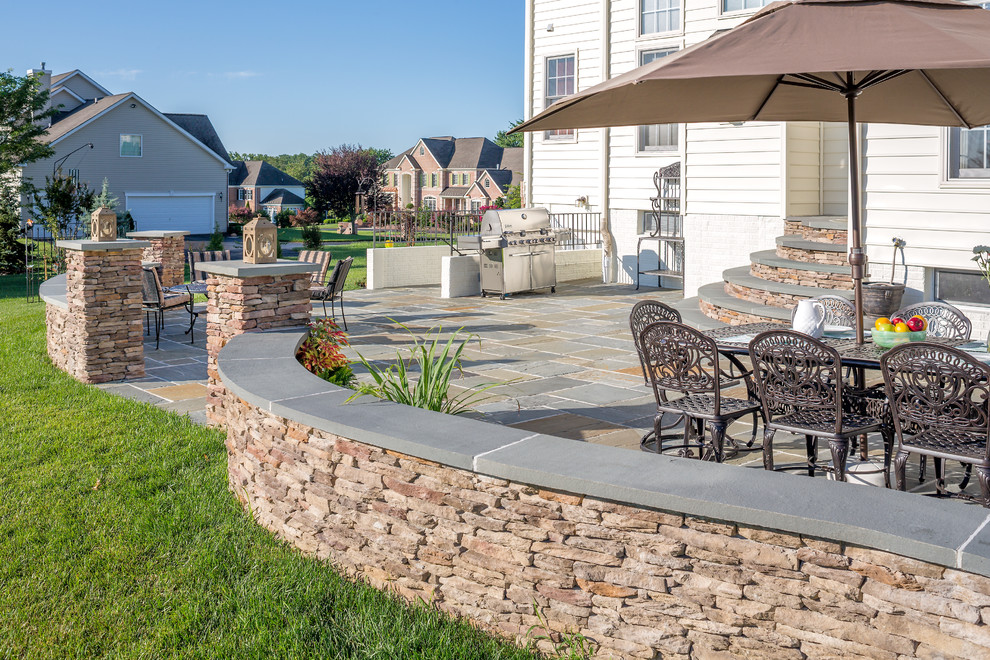 Inspiration for a contemporary backyard patio in Baltimore with natural stone pavers.