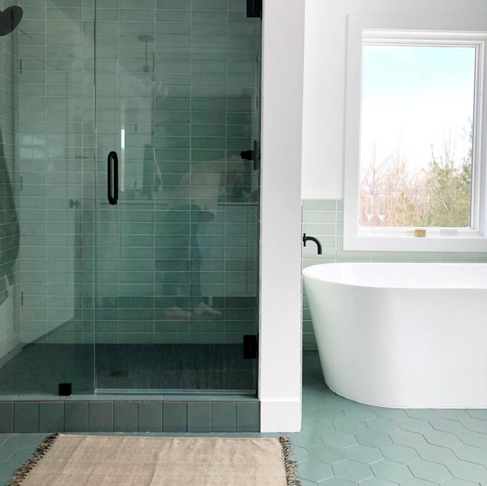 Large scandinavian master bathroom in Grand Rapids with flat-panel cabinets, white cabinets, a freestanding tub, an alcove shower, green tile, ceramic tile, white walls, ceramic floors, an undermount sink, quartzite benchtops, green floor, a hinged shower door and white benchtops.