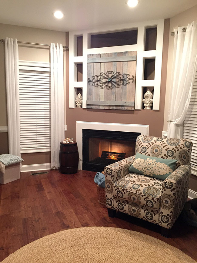 Inspiration for a mid-sized traditional formal enclosed living room in Orange County with beige walls, dark hardwood floors, a corner fireplace, a plaster fireplace surround, a concealed tv and brown floor.