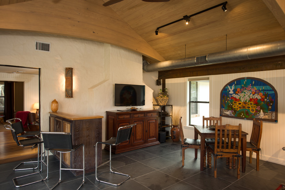 Example of a mid-sized mountain style enclosed slate floor home design design in Austin with a bar, white walls and a wall-mounted tv