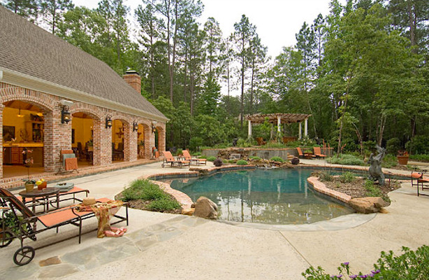 Inspiration for an expansive arts and crafts backyard custom-shaped lap pool in Dallas with a hot tub and brick pavers.