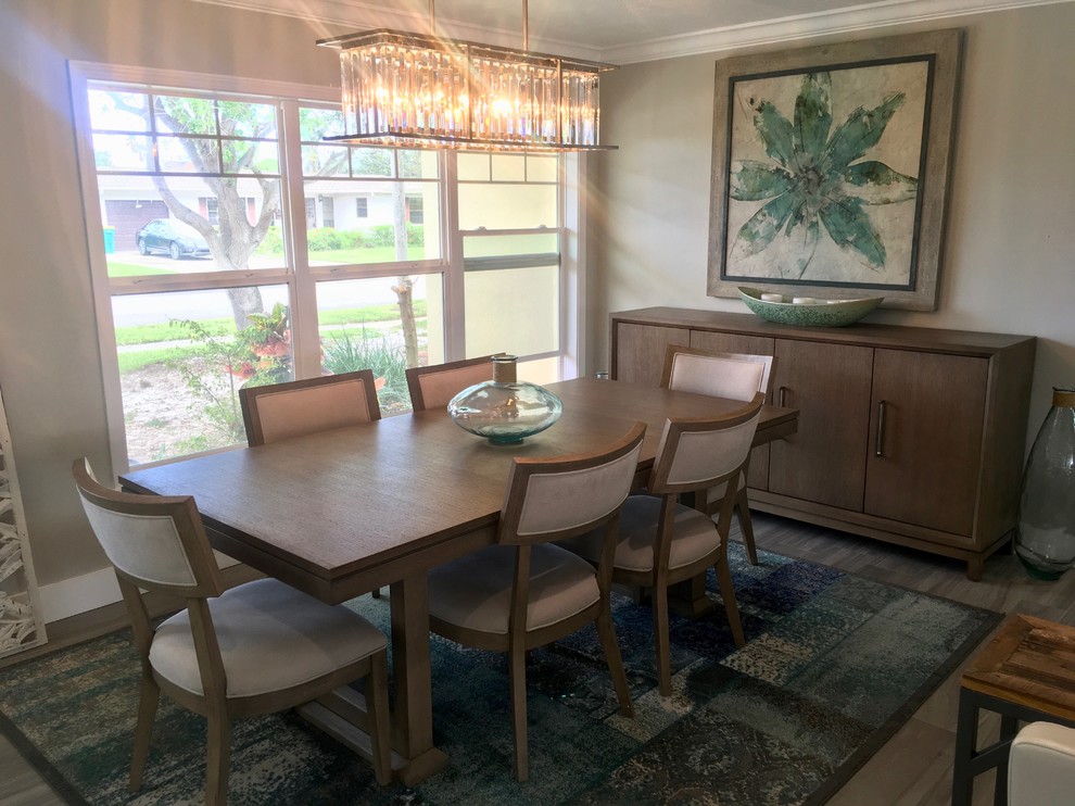 Photo of a small traditional separate dining room in Orlando with brown floor, no fireplace, grey walls and vinyl floors.