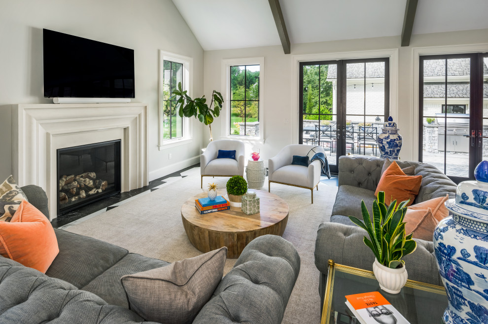 Inspiration for an expansive transitional open concept living room in Providence with a home bar, white walls, porcelain floors, a standard fireplace, a stone fireplace surround, a wall-mounted tv and vaulted.