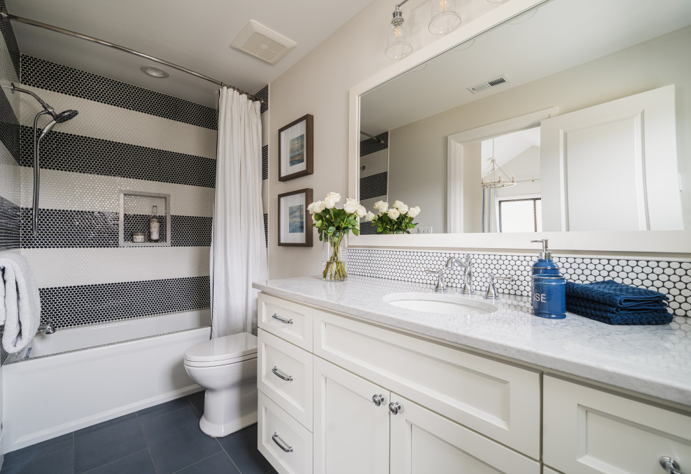 This is an example of a mid-sized beach style bathroom in Seattle with recessed-panel cabinets, white cabinets, an alcove tub, blue tile, ceramic tile, porcelain floors, an undermount sink, engineered quartz benchtops, blue floor, grey benchtops, a single vanity, a built-in vanity, a shower/bathtub combo, white walls and a shower curtain.