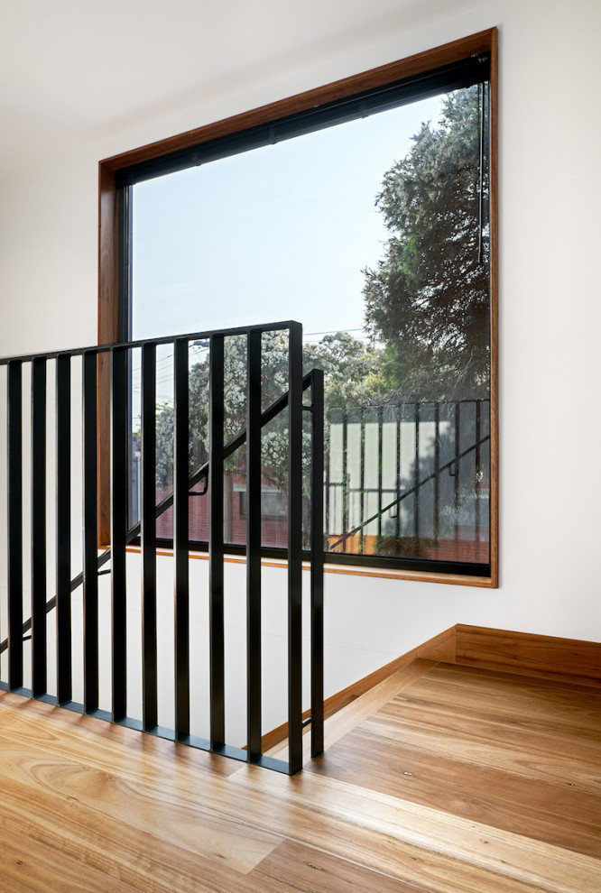 Medium sized contemporary wood straight metal railing staircase in Melbourne with wood risers.