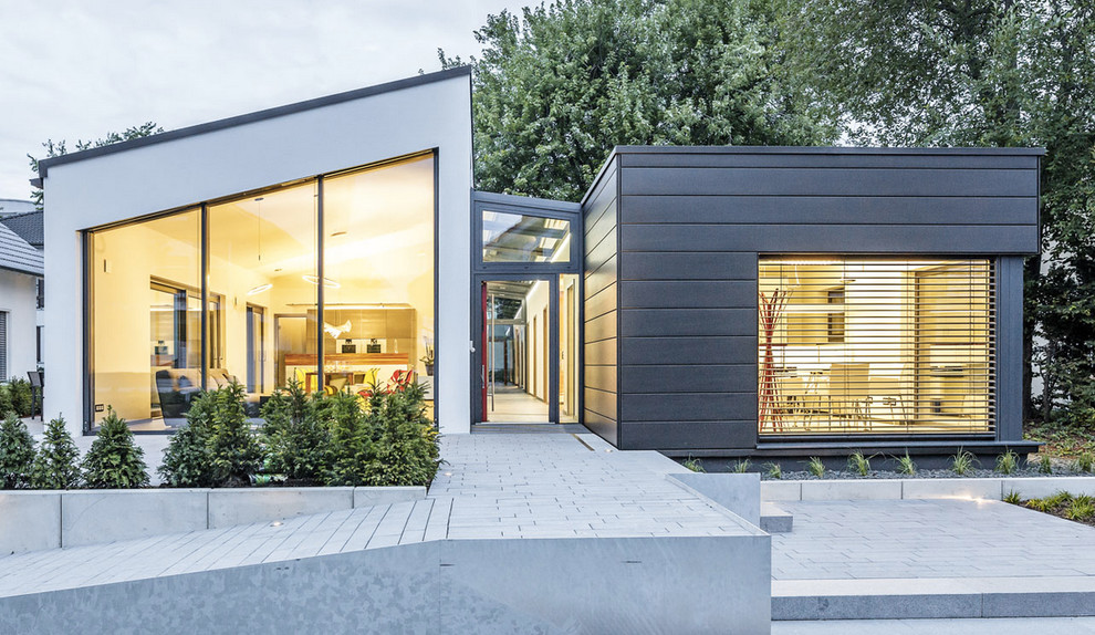 Large contemporary one-storey grey exterior in Stuttgart with mixed siding and a shed roof.