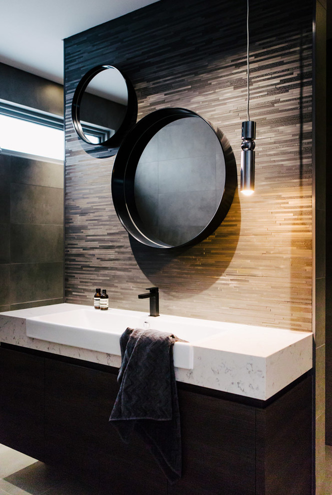 Inspiration for a contemporary bathroom in Sydney with flat-panel cabinets, black cabinets, a one-piece toilet, black tile, gray tile, cement tile, grey walls, cement tiles and marble benchtops.