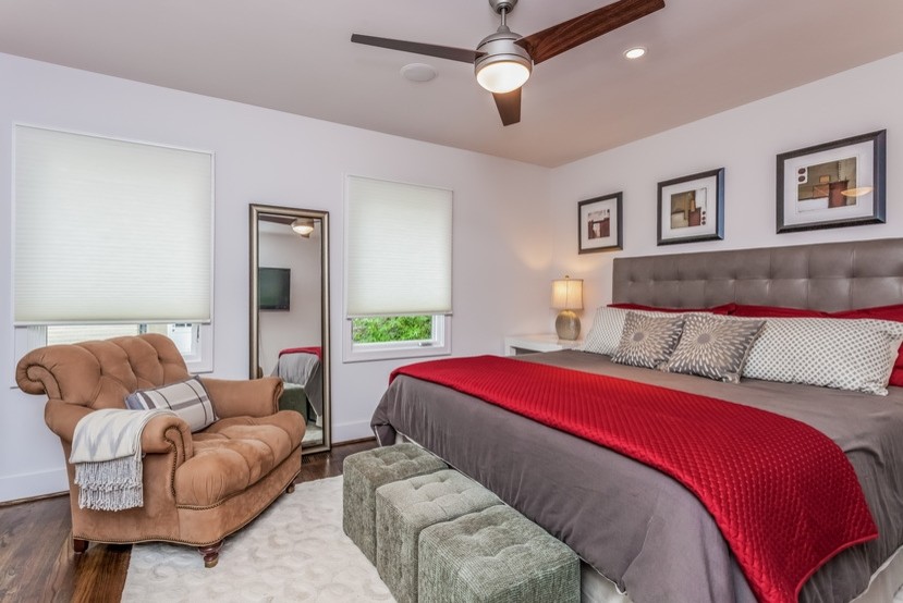 Photo of a contemporary bedroom in Atlanta with grey walls and medium hardwood floors.