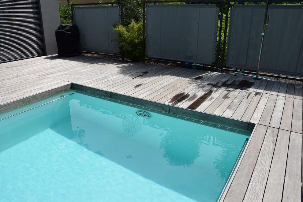 Photo of a large traditional side yard rectangular pool in Frankfurt with decking.