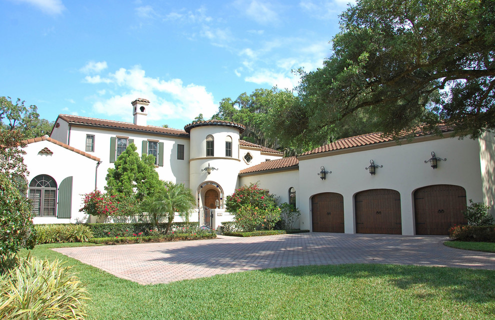This is an example of a large mediterranean two-storey stucco white exterior in Orlando.