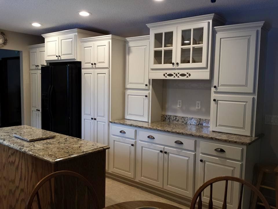 Design ideas for a country galley kitchen in St Louis with a double-bowl sink, raised-panel cabinets, white cabinets, granite benchtops, black appliances and with island.