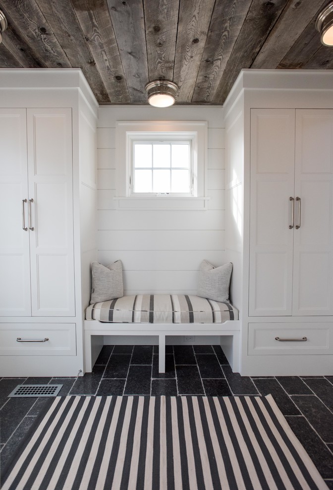 Inspiration for a beach style mudroom in Boston with white walls.