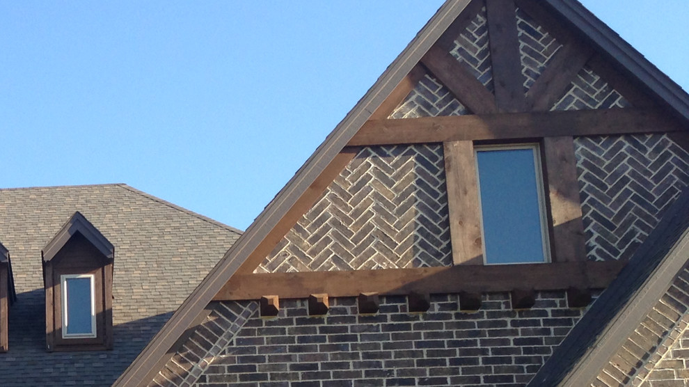 Photo of a mid-sized transitional two-storey brick brown house exterior in Orange County with a gable roof and a shingle roof.