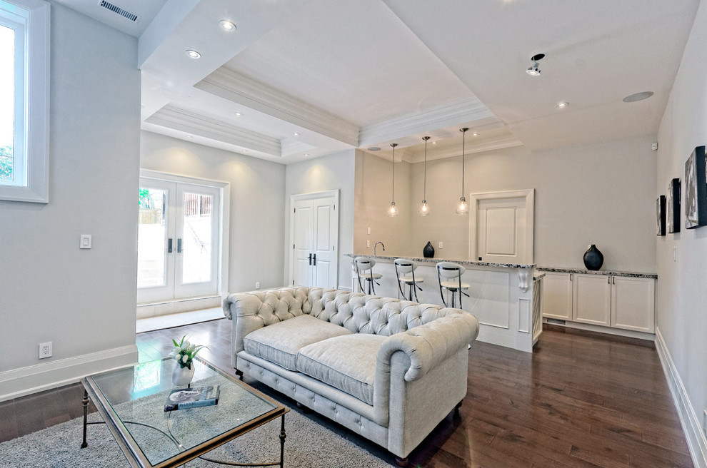 Example of a mid-sized transitional walk-out medium tone wood floor basement design in Toronto with gray walls and a standard fireplace