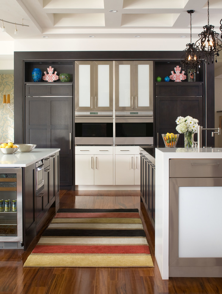 Inspiration for a contemporary kitchen in Denver with dark wood cabinets and panelled appliances.
