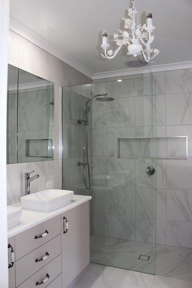 Photo of a mid-sized contemporary master bathroom in Other with flat-panel cabinets, beige cabinets, an open shower, white tile, ceramic tile, white walls, ceramic floors, a vessel sink, engineered quartz benchtops, white floor, an open shower and white benchtops.