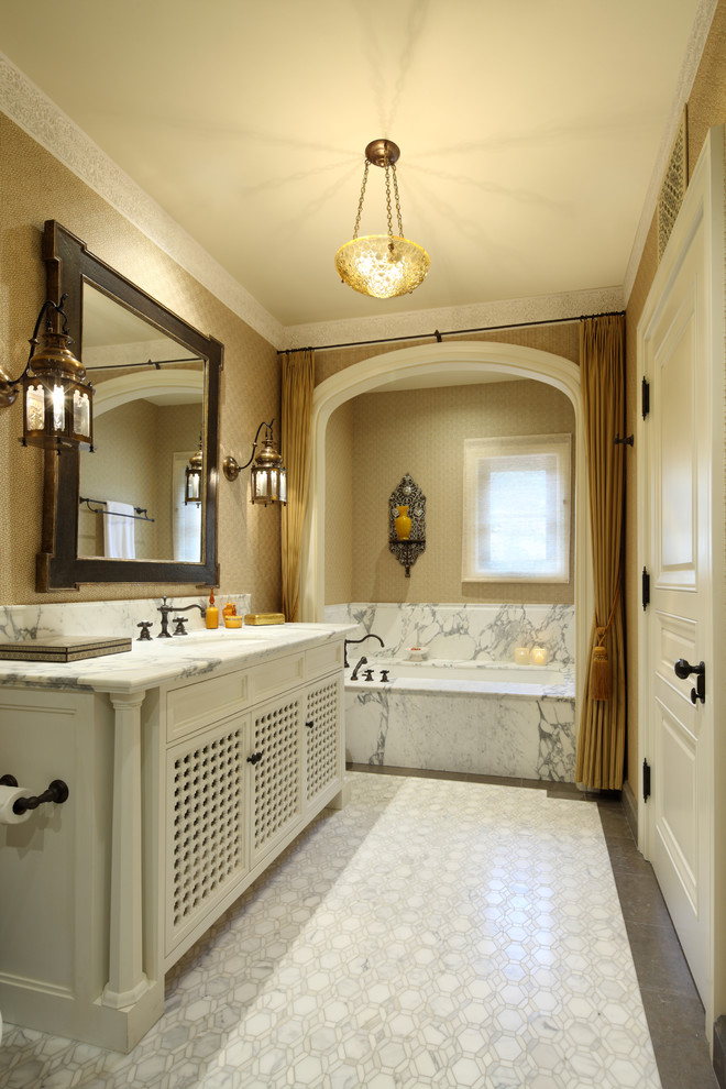 Inspiration for a mediterranean bathroom in San Francisco with an undermount sink, recessed-panel cabinets, beige cabinets, an undermount tub and white tile.