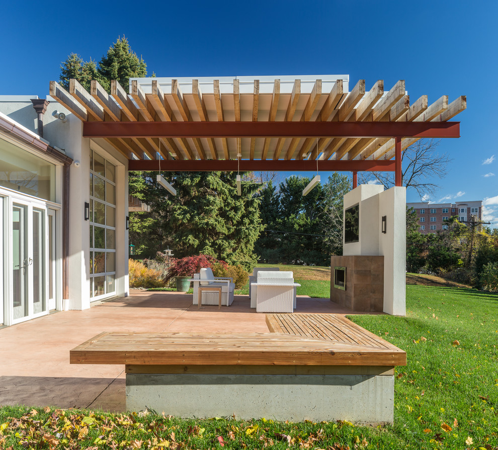 Design ideas for a contemporary backyard patio in Los Angeles with a pergola and with fireplace.