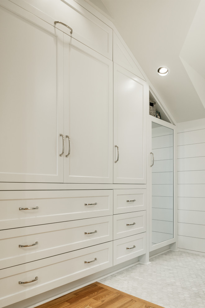 Built-in closet - mid-sized coastal medium tone wood floor and vaulted ceiling built-in closet idea in Seattle with shaker cabinets and white cabinets