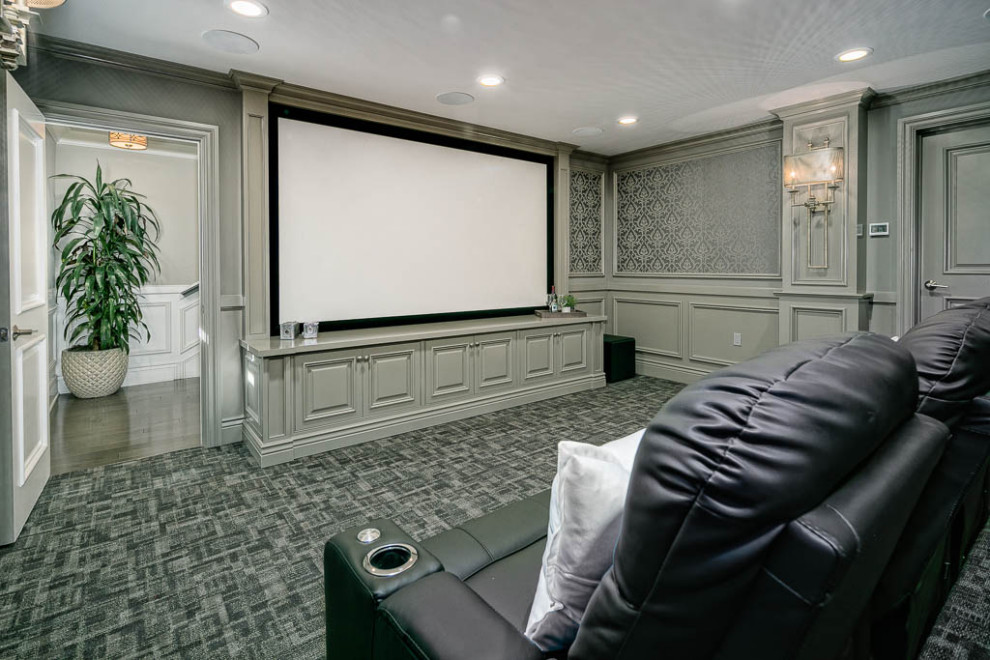 Inspiration for a large traditional enclosed home theatre in Los Angeles with beige walls, dark hardwood floors and brown floor.
