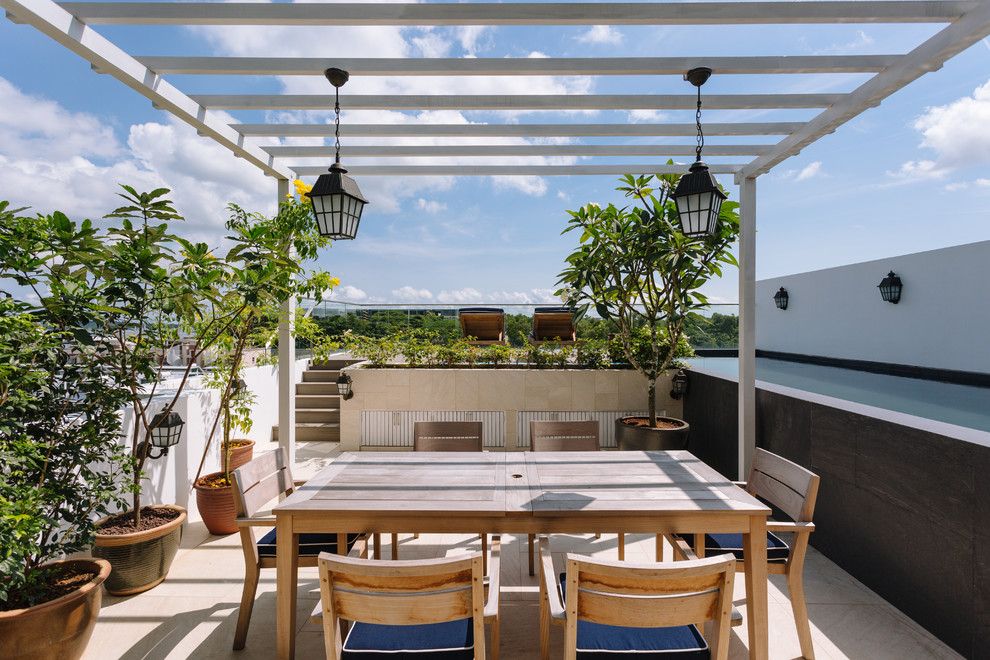 Asian rooftop and rooftop deck in Singapore with a container garden and a pergola.