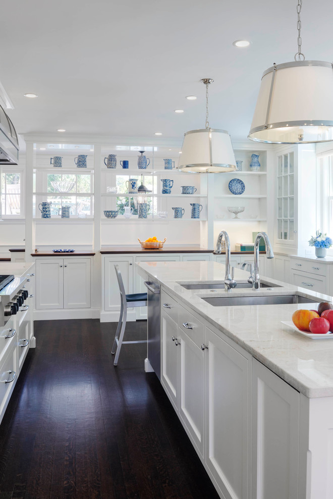 Mid-sized traditional u-shaped open plan kitchen in Boston with an undermount sink, shaker cabinets, white cabinets, marble benchtops, white splashback, subway tile splashback, stainless steel appliances, dark hardwood floors, with island and brown floor.