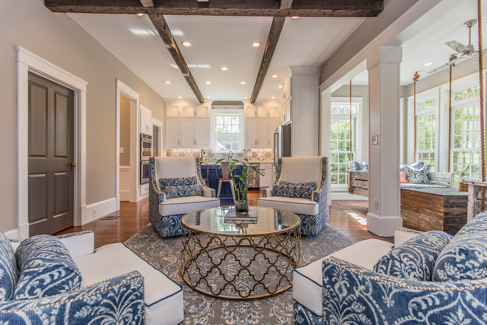 Example of a mid-sized transitional open concept medium tone wood floor and brown floor family room design in Other with blue walls, a standard fireplace, a wood fireplace surround and a wall-mounted tv