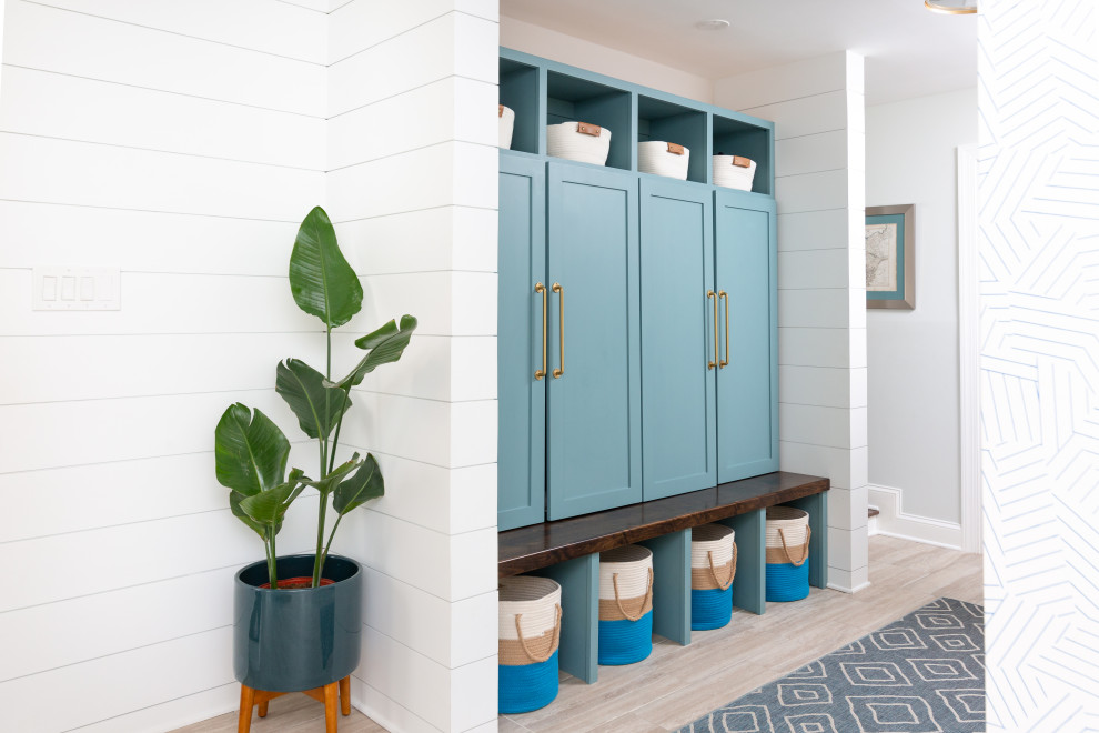 Inspiration for a medium sized beach style boot room in Baltimore with white walls, ceramic flooring, a single front door, a blue front door, multi-coloured floors and tongue and groove walls.