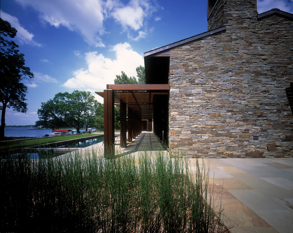 Inspiration for a transitional one-storey exterior in Minneapolis with stone veneer.