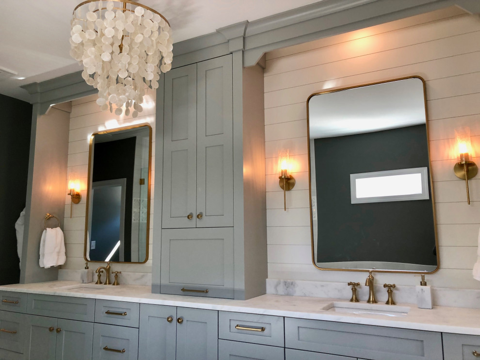 This is an example of a mid-sized midcentury master bathroom in Charlotte with flat-panel cabinets, grey cabinets, a drop-in tub, a corner shower, gray tile, porcelain tile, grey walls, marble floors, an undermount sink, marble benchtops, multi-coloured floor, a hinged shower door, white benchtops, a shower seat, a double vanity, a built-in vanity and planked wall panelling.
