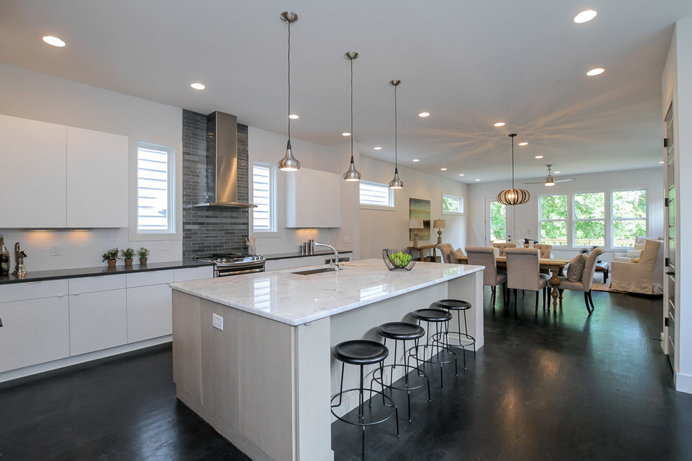 Open concept kitchen - large modern single-wall dark wood floor and brown floor open concept kitchen idea in Nashville with an undermount sink, flat-panel cabinets, white cabinets, quartzite countertops, gray backsplash, glass tile backsplash, stainless steel appliances and an island