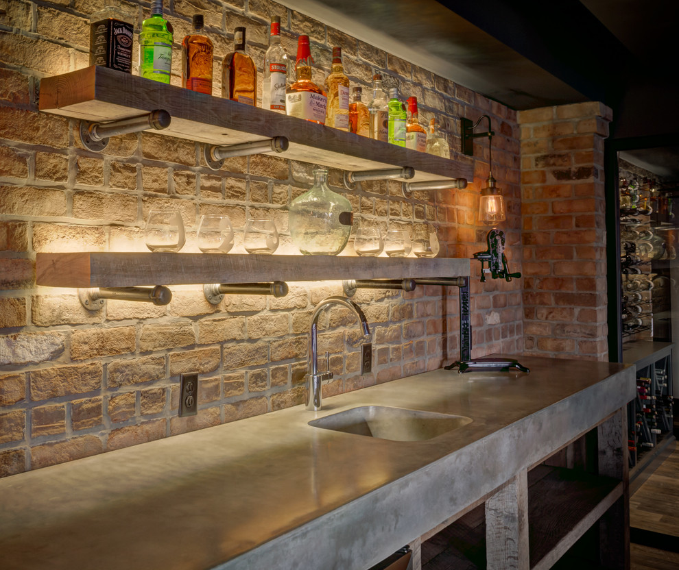 This is an example of a large country wet bar in Cleveland with an integrated sink, concrete benchtops, brick splashback and vinyl floors.