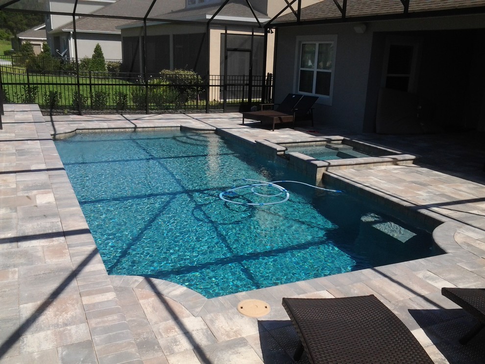 Example of a mid-sized transitional indoor concrete paver and custom-shaped hot tub design in Orlando
