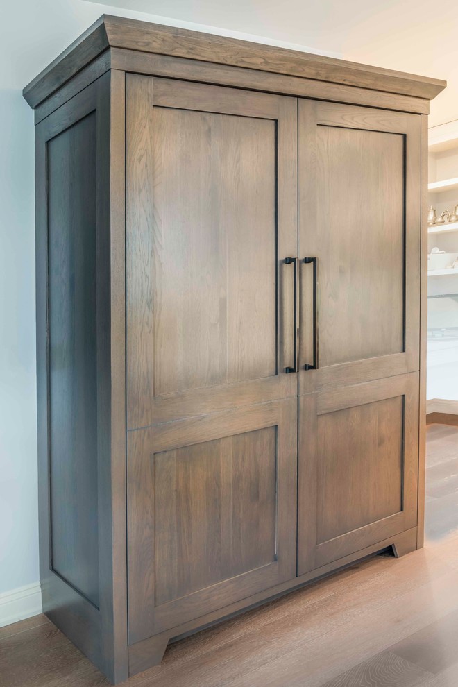 Home design - mid-sized transitional u-shaped medium tone wood floor and brown floor home design idea in Calgary with an undermount sink, marble countertops, gray backsplash, ceramic backsplash, paneled appliances, an island, shaker cabinets and brown cabinets
