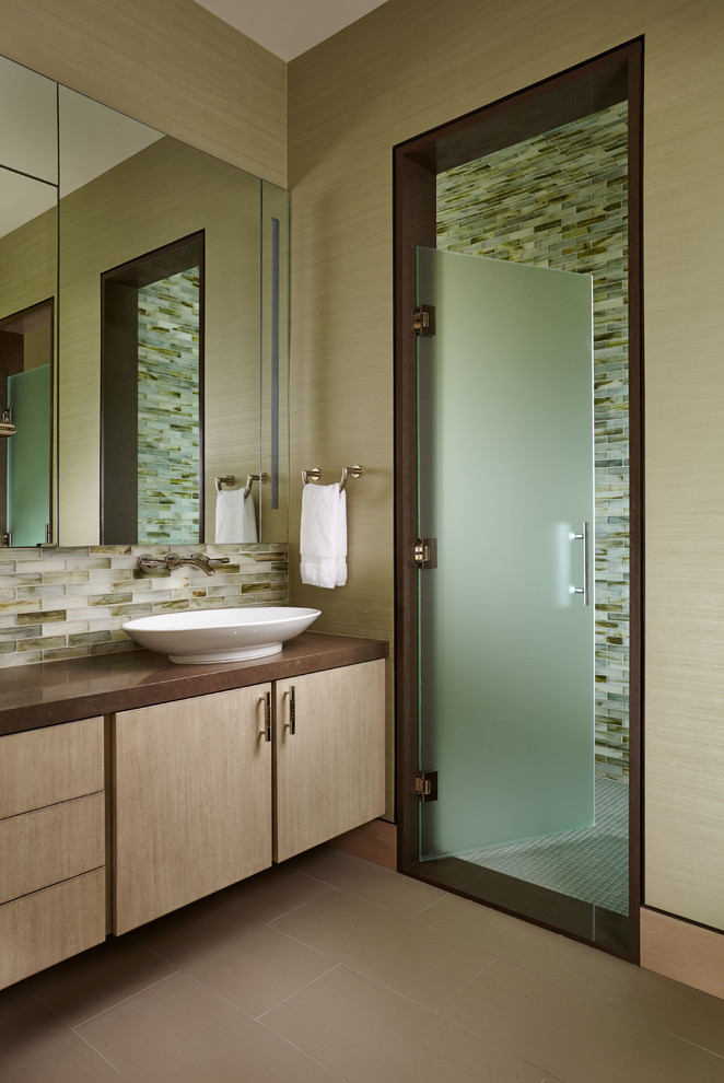Mid-sized asian bathroom in Wichita with flat-panel cabinets, light wood cabinets, beige tile, brown tile, white tile, glass tile, beige walls, linoleum floors, a vessel sink, granite benchtops, with a sauna, an alcove shower, brown floor and a hinged shower door.