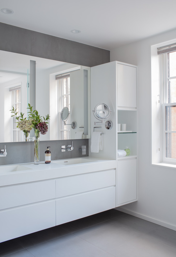 Large trendy master gray tile and porcelain tile porcelain tile, gray floor and double-sink bathroom photo in Boston with flat-panel cabinets, white cabinets, white walls, an integrated sink, white countertops and a floating vanity