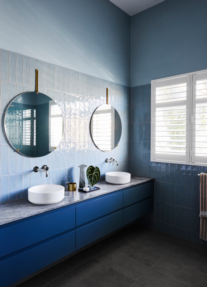 Inspiration for a contemporary bathroom in Melbourne with flat-panel cabinets, blue cabinets, blue tile, blue walls, a vessel sink, grey floor, grey benchtops, a double vanity and a floating vanity.