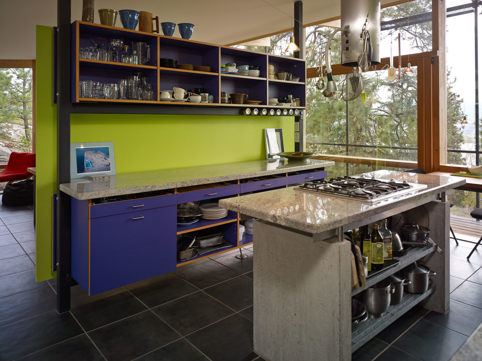 Photo of a modern kitchen in Vancouver with flat-panel cabinets, blue cabinets and stainless steel appliances.