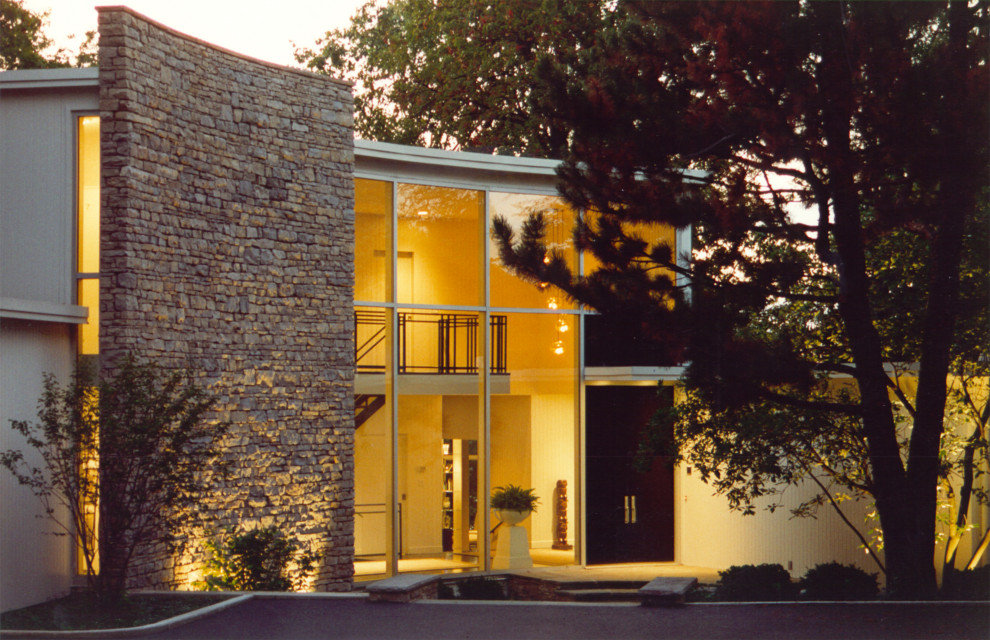 Photo of a contemporary stucco white exterior in Other with a flat roof.