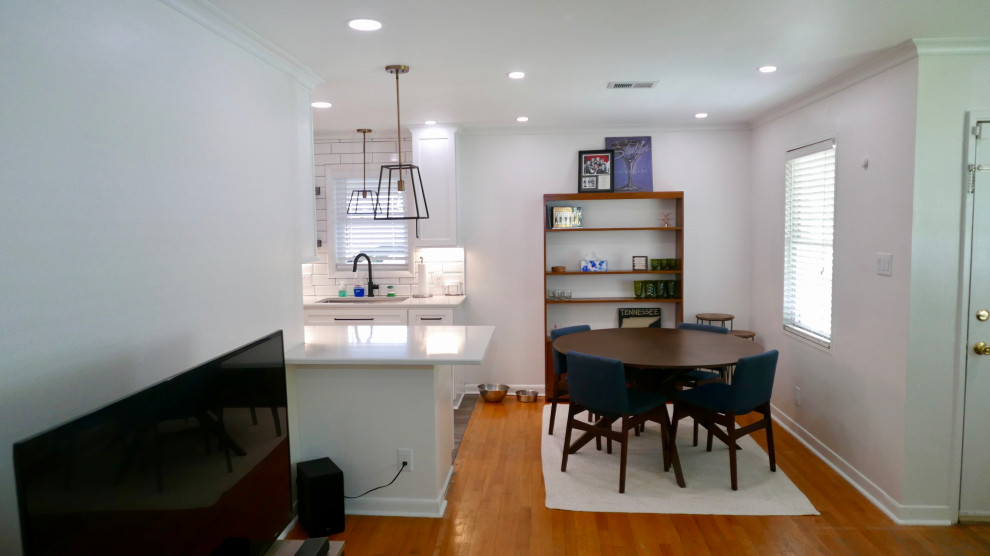 Mid-sized transitional galley porcelain tile and gray floor eat-in kitchen photo with an undermount sink, shaker cabinets, white cabinets, quartz countertops, white backsplash, subway tile backsplash, black appliances, no island and white countertops
