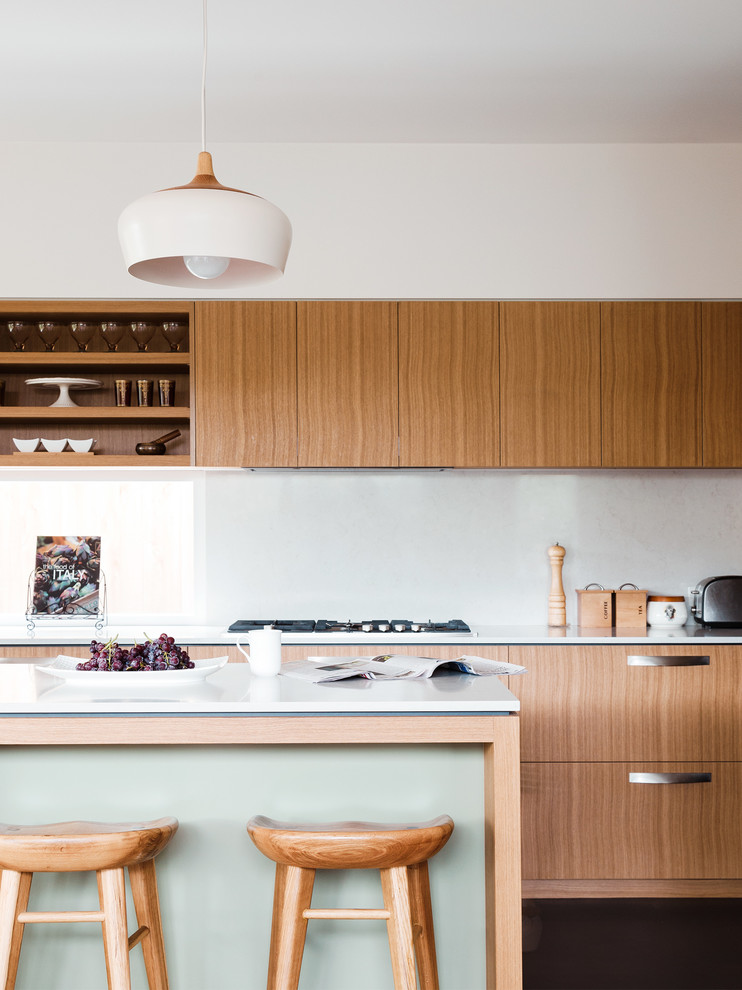 Photo of a mid-sized contemporary u-shaped eat-in kitchen in Melbourne with a double-bowl sink, medium wood cabinets, quartz benchtops, white splashback, stone slab splashback, stainless steel appliances and with island.
