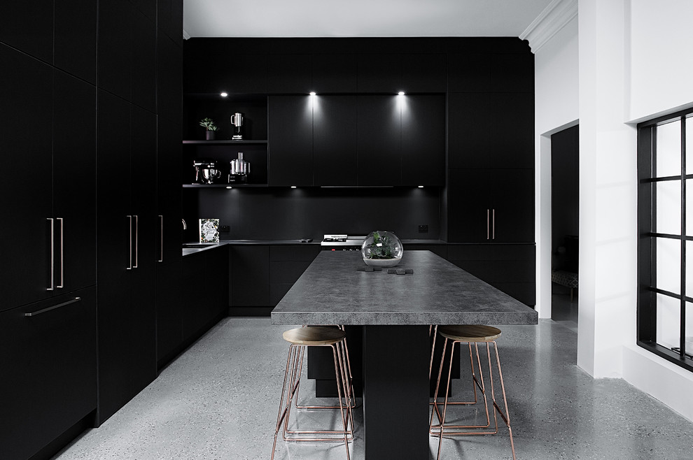 This is an example of a large industrial galley separate kitchen in Hobart with flat-panel cabinets, black cabinets, concrete benchtops, with island and grey benchtop.