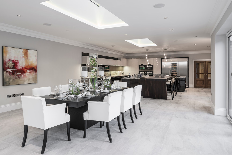 This is an example of an expansive contemporary open plan dining in Buckinghamshire with ceramic floors and grey floor.