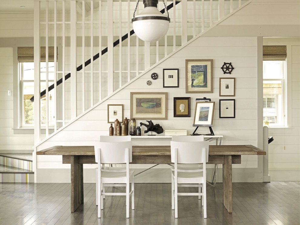 Inspiration for a beach style dining room in New York with white walls and dark hardwood floors.