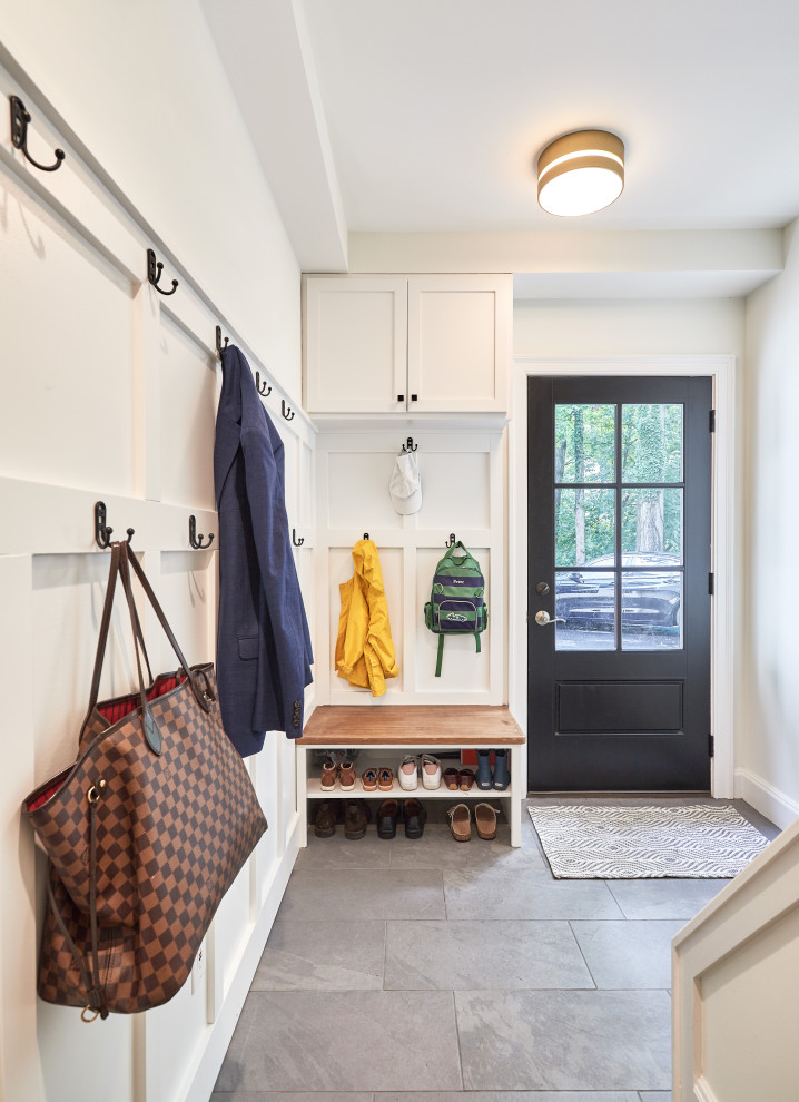 Small traditional mudroom in Cincinnati with white walls, porcelain floors, a single front door, a black front door, grey floor and panelled walls.