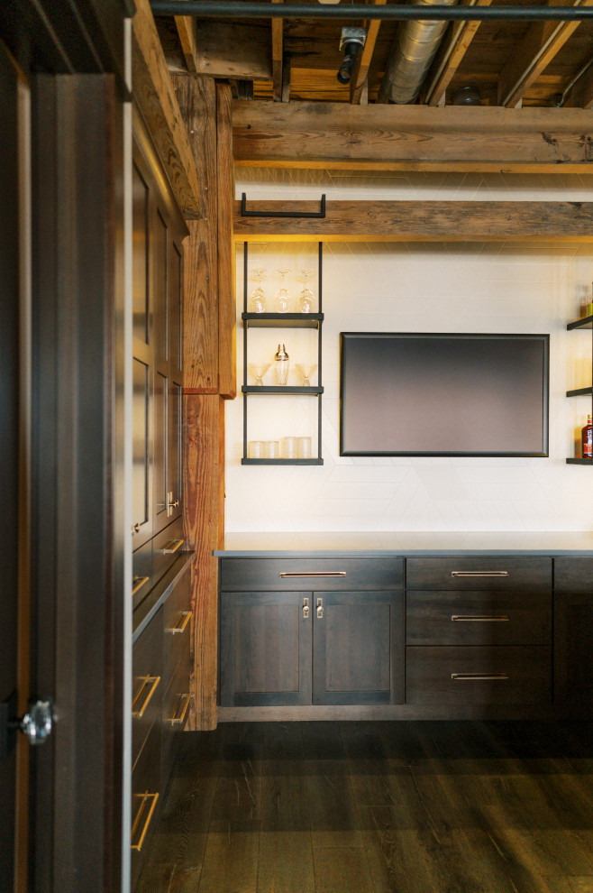 Photo of a mid-sized modern galley home bar in Cedar Rapids with an undermount sink, shaker cabinets, dark wood cabinets, quartz benchtops and dark hardwood floors.