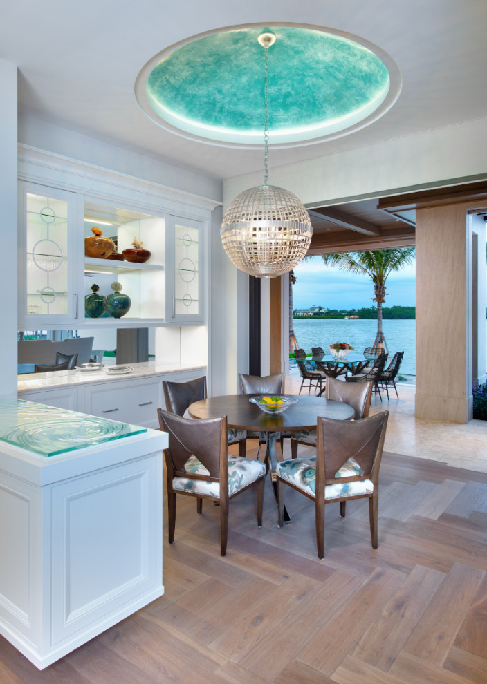 Mid-sized beach style open plan dining in Other with white walls, medium hardwood floors and beige floor.