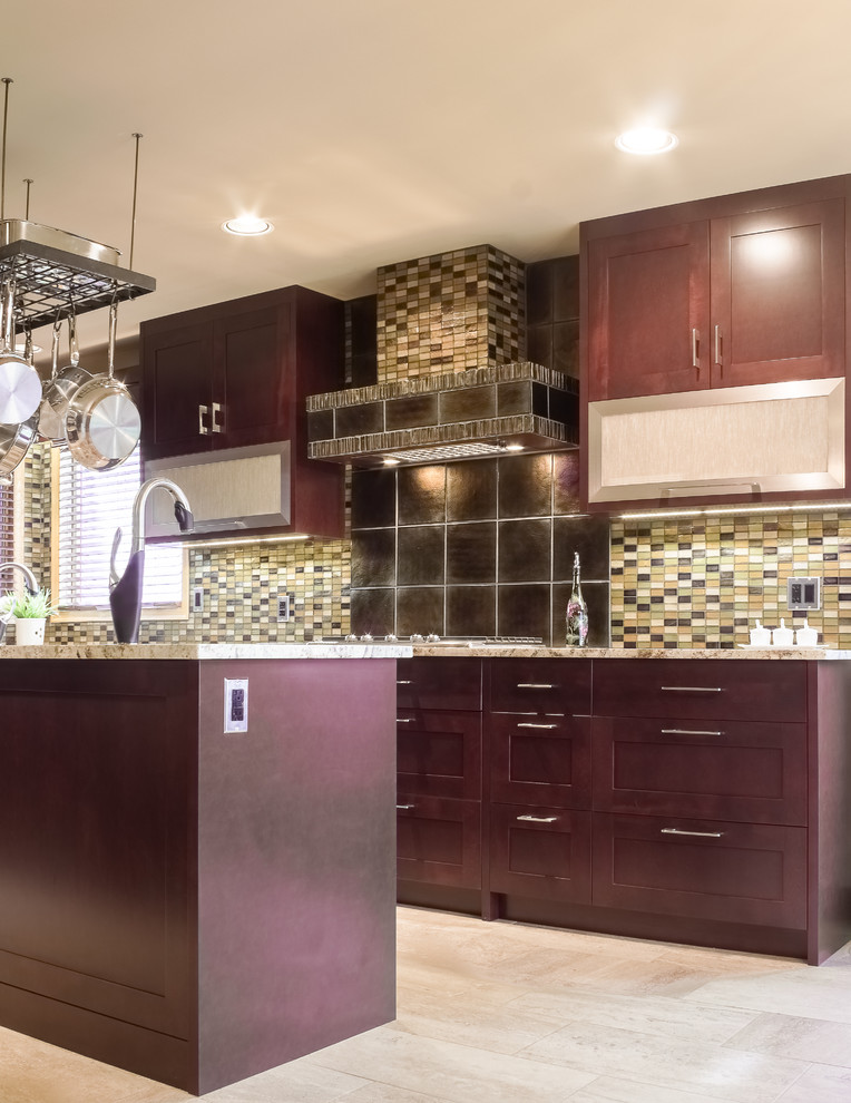 Trendy ceramic tile kitchen photo with a double-bowl sink, shaker cabinets, dark wood cabinets, granite countertops, multicolored backsplash, glass tile backsplash, paneled appliances and an island