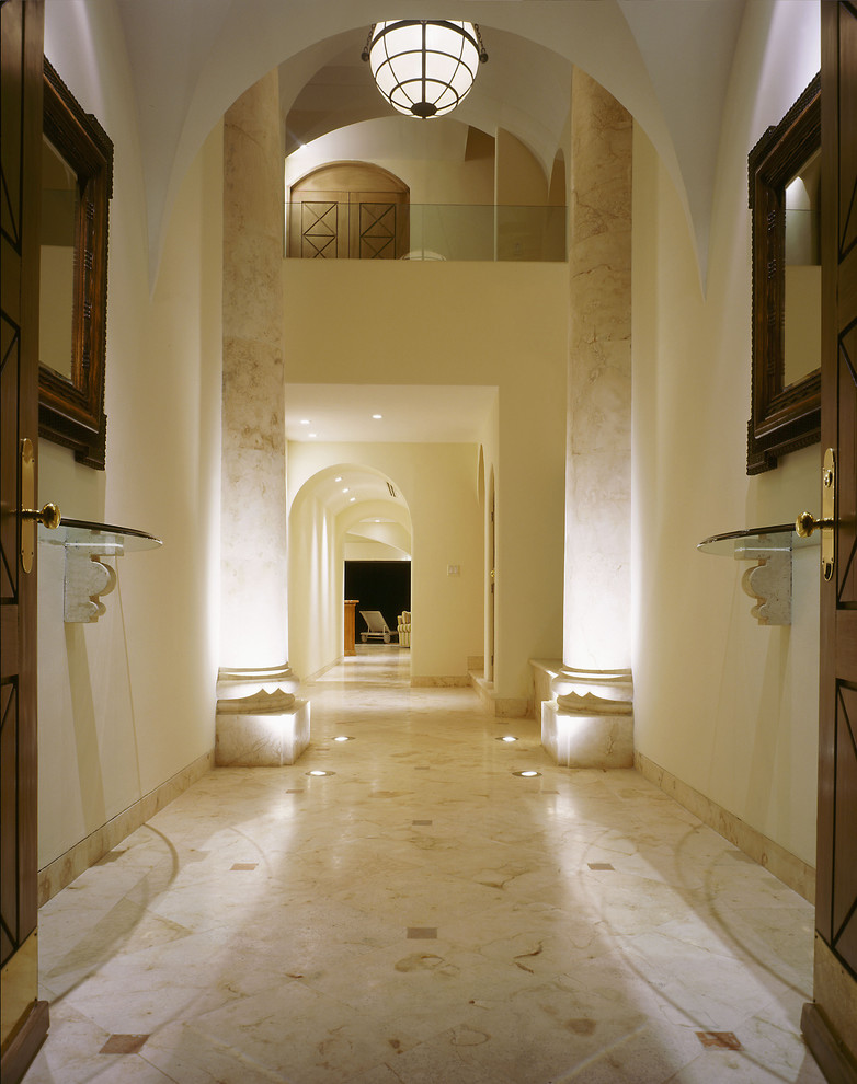 Photo of an expansive mediterranean entryway in Other with beige walls, a double front door and marble floors.